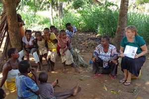 Peace Corps volunteer Kelly Sawyer speaks with mothers about preventing malaria in pregnancy