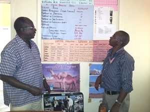 Dr. Chris Ajele (left), shares some local livestock statistics with CDC Kenya GIS Specialist Daniel Macharia (rt)