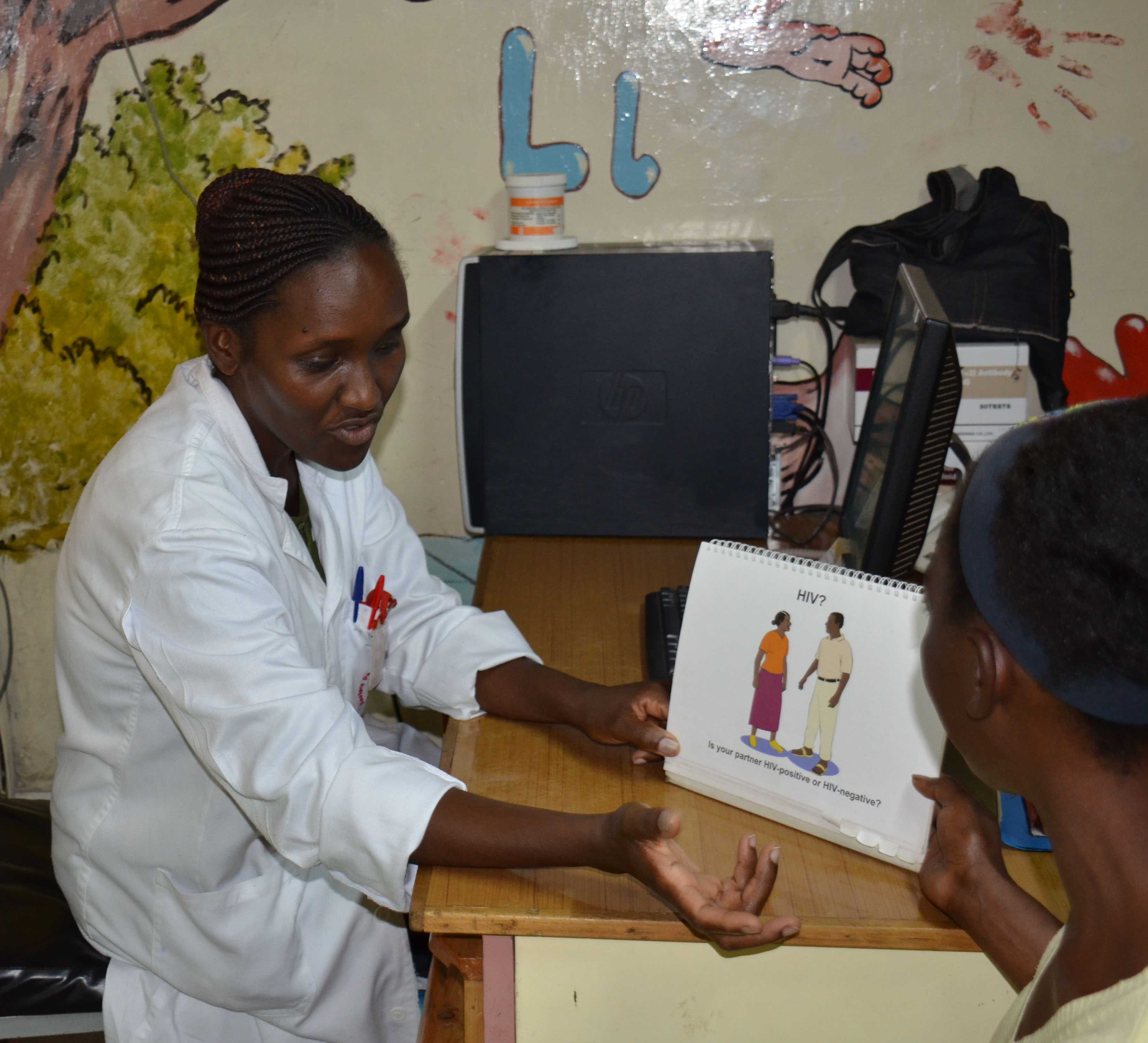 	Jelius Muraguri, PMTCT nurse at EDARP, discusses HIV prevention and care with one of the mothers attending CDC- supported Komarock Clinic