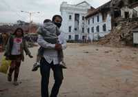 	People walk past rubble in Kathmandus Durbar Square, a UNESCO World Heritage Site that was severely damaged by an earthquake on April 25, 2015.