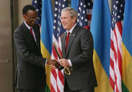 Photo of President Bush and the first lady as they talk with students of Lycee de Kigali High School’s ‘Anti-AIDS Club’