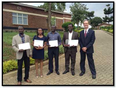 Four Cohort 1 Rwanda FELTP residents (Left to Right: Claude Rutanga, Marie Aimee Muhimpundu, Jean Felix Kinani, Hinda Ruton posing with Dr. Douglas Shaffer CDC Rwanda Country Director, after receiving their completion certificates during the University of Rwanda, School of Public Health’s 2013 Scientific Day held on Dec 3rd 2013.