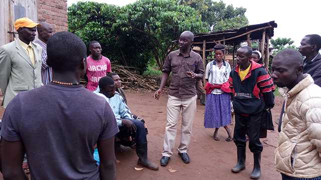 Ben Masiira a fellow, sensiting community members. 