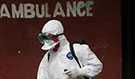 A health care worker decontaminates the ambulance area outside of Redemption Hospital in Monrovia, Liberia