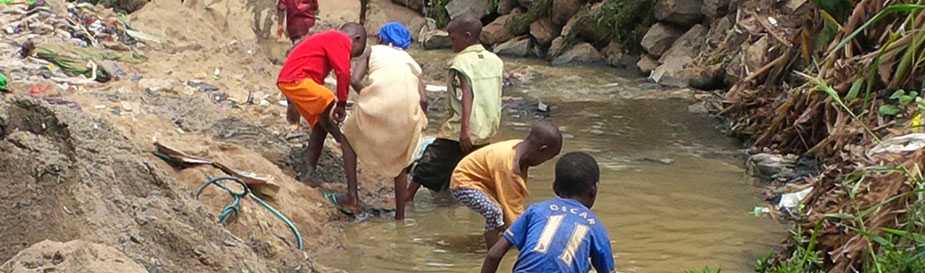 Children in Mpape community (Nigeria) play in a waste water drainage area. This drainage was the suspected source of contamination of the well water that led to the cholera outbreak investigated by Nigeria FELTP residents in April 2014. Two samples collected from home wells around this drainage tested positive for Vibrio Cholerae. Submitted by Amibola Aman-Oloniyo - Nigeria.