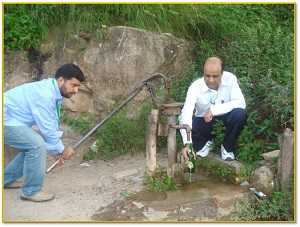 FETP Pakistan graduates Dr. Furgan and Dr. Muhammad Bilal Khan try to collect another water sample from a second source of community drinking water in the Punjab province in Pakistan. 