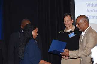 CDC's Kip Baggett and TEPHINET's Carl Reddy congratulate poster presenters at FETP International Night.