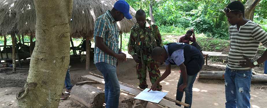 Dr. Alain (on the left in blue hat) from the Democratic Republic of Congo at a check point during border control efforts in Forécariah, Guinea.