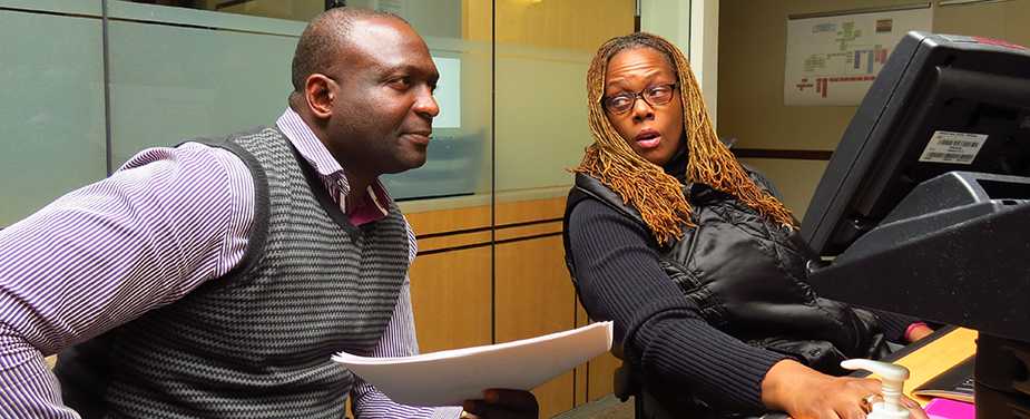 Dr. Amadou Traore shadows Watch Officer Cassandra Rolle at the Watch Desk in CDC’s EOC.