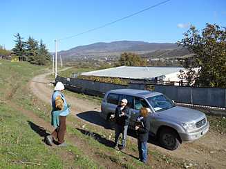 A survey team (on the right) investigating a potential outbreak of Crimean-Congo Hemorrhagic Fever, looking for a study participant at the edge of a herding field in Georgia. 