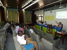 Dr. Ezra Barzilay, CDC NPHI Program, guides staff from Togo's INH through a discussion of their public health system.