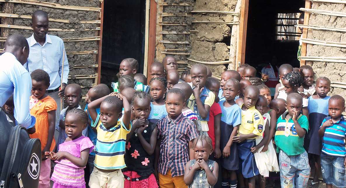 Children patiently wait their turn for the polio drops