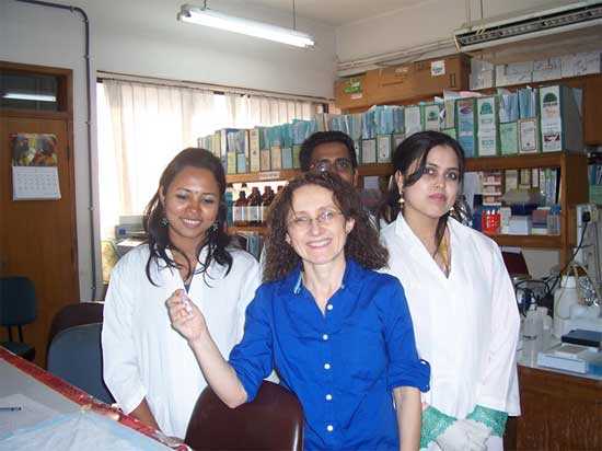 	CDC’s Conchi Estivariz holds up a tube with serum from a child participating in the study with colleagues at the laboratory of ICDDR,b in Bangladesh. The staff at ICDDRB had processed the blood to obtain sera, which was sent to the CDC lab in Atlanta to measure antibodies against poliovirus and determine which polio vaccine or which vaccine schedule was more effective.  