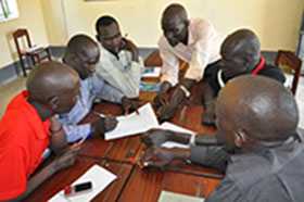 South Sudanese immunization officers working on a case study to apply new knowledge