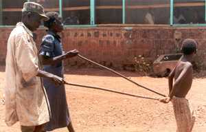 A child leading elders blinded by onchocerciasis. Credit: Carter Center.