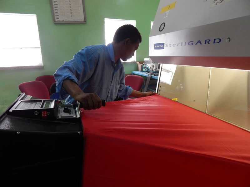 	An engineer in training assessing a biosafety cabinet during a classroom observation period.