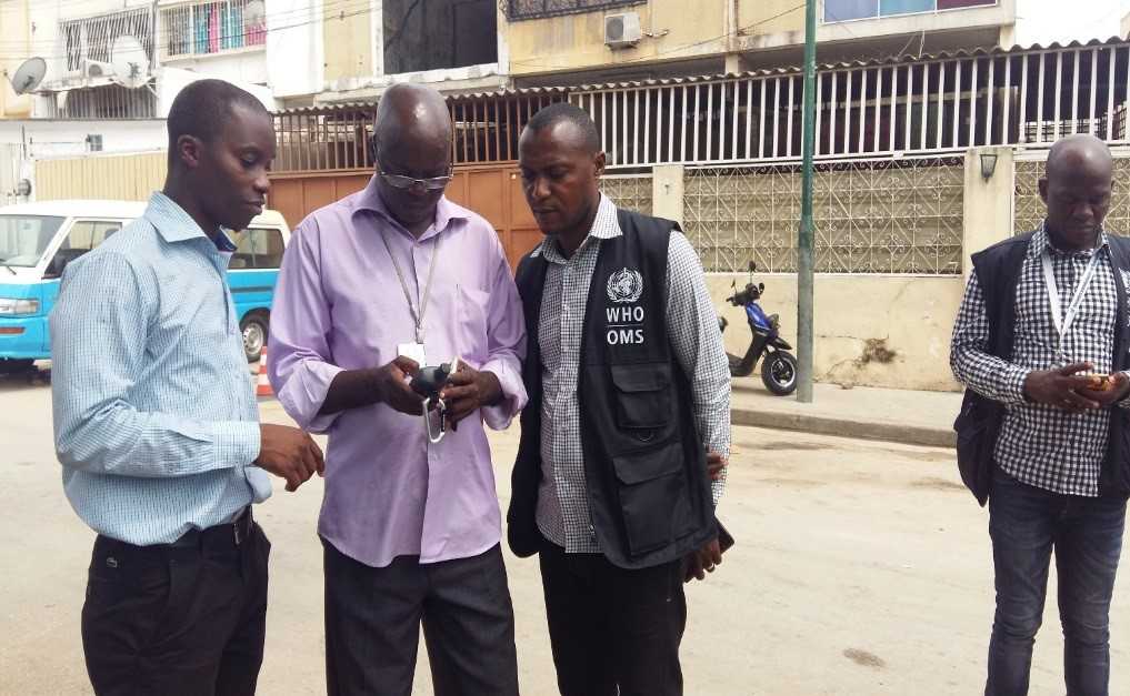 	Mozambique FETP Resident Claudio Muianga (left), works with colleagues in Angola