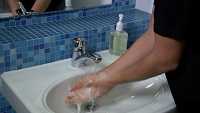 man washing his hands with soap and water