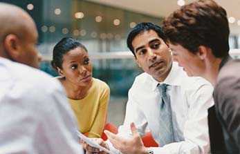 Group of four people in a meeting.