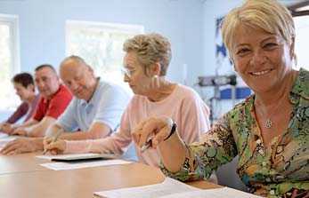 	Group of Older Adults sitting in a classroom.