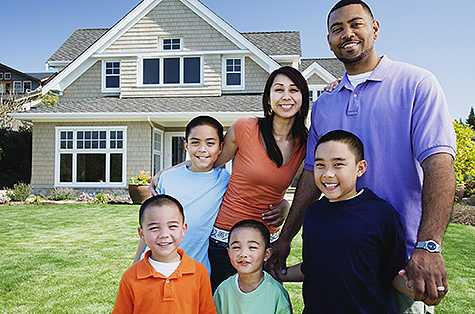 family standing outside of house