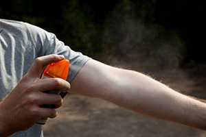 man applying insect repellent