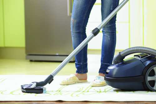 woman vacuuming carpet