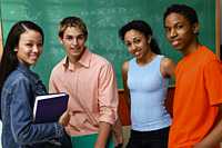 Four students by chalkboard