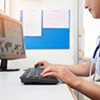 school nurse working at computer