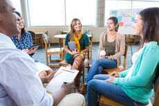 Group of people sitting in a circle, talking