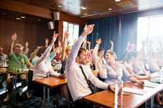 People in room raising hands