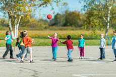 Kids on playground with a ball