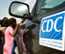 children standing next to a CDC truck