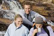 	Photo of travelers drinking water from a waterfall