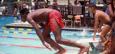 	Young boy diving into a pool