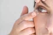 woman inserting contact lens