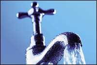 Water pouring out of a faucet.