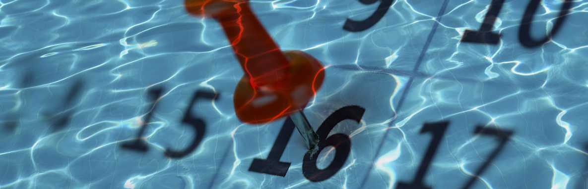 	a reflective pool bottom with calendar date boxes resembling pool tiles