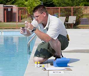 checking the chemicals at a public pool