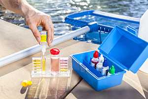 man testing chlorine levels with a testing kit