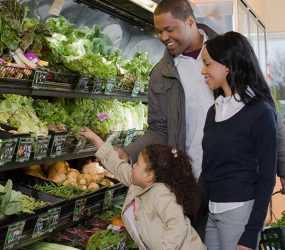 Photo:  A family shopping for fruits and vegetables