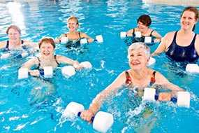 	photo of women exercising in a swimming pool