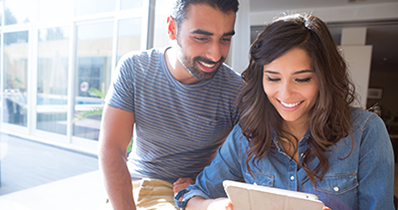 photo of an Hispanic couple looking at a laptop