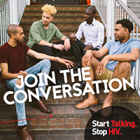 Four men sitting on stairs looking at each other 