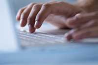 	photograph of fingers on a computer keyboard