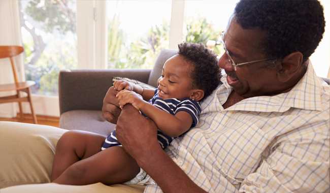 Grandfather with toddler in lap.