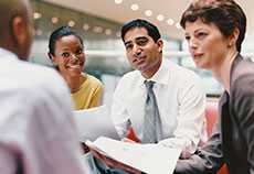 Business People Sitting Talking in an Office Building 