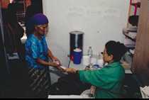 Nurse handing patient materials.