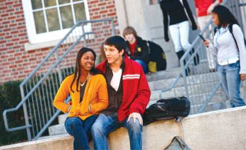 Teenage girl and boy sitting together.