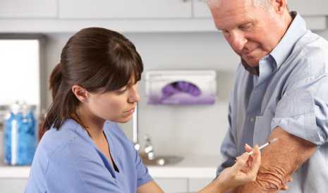 Man getting a vaccinaton shot in his arm.